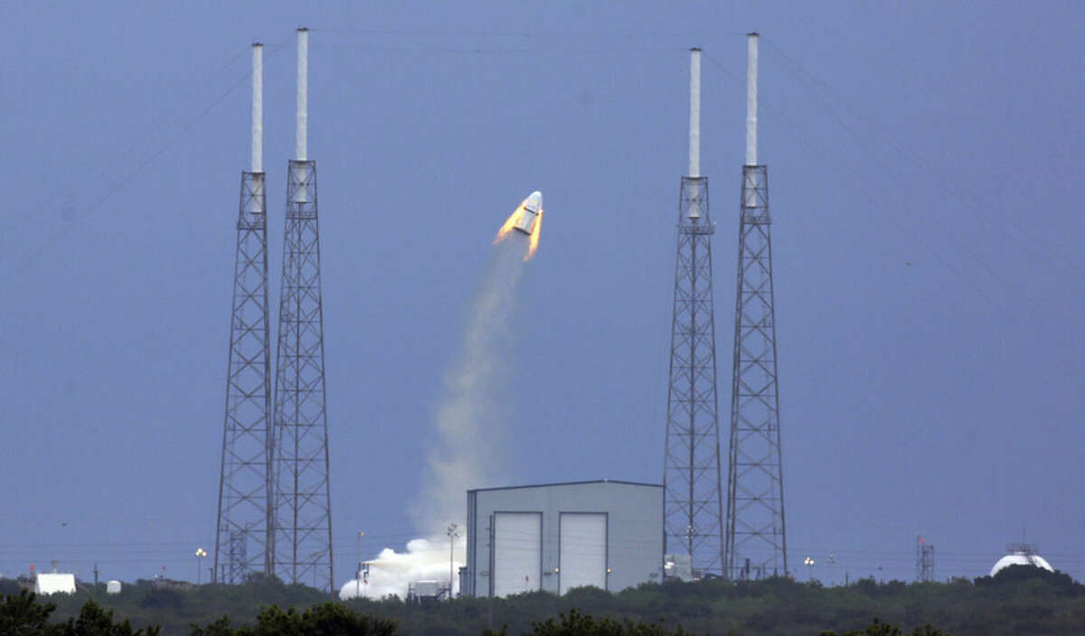 SpaceX's Dragon capsule launches, Wednesday, May 6, 2015, from Cape Canaveral, Fla. SpaceX fired the mock-up capsule to test the new, super-streamlined launch escape system for astronauts. (Red Huber/Orlando Sentinel via AP)