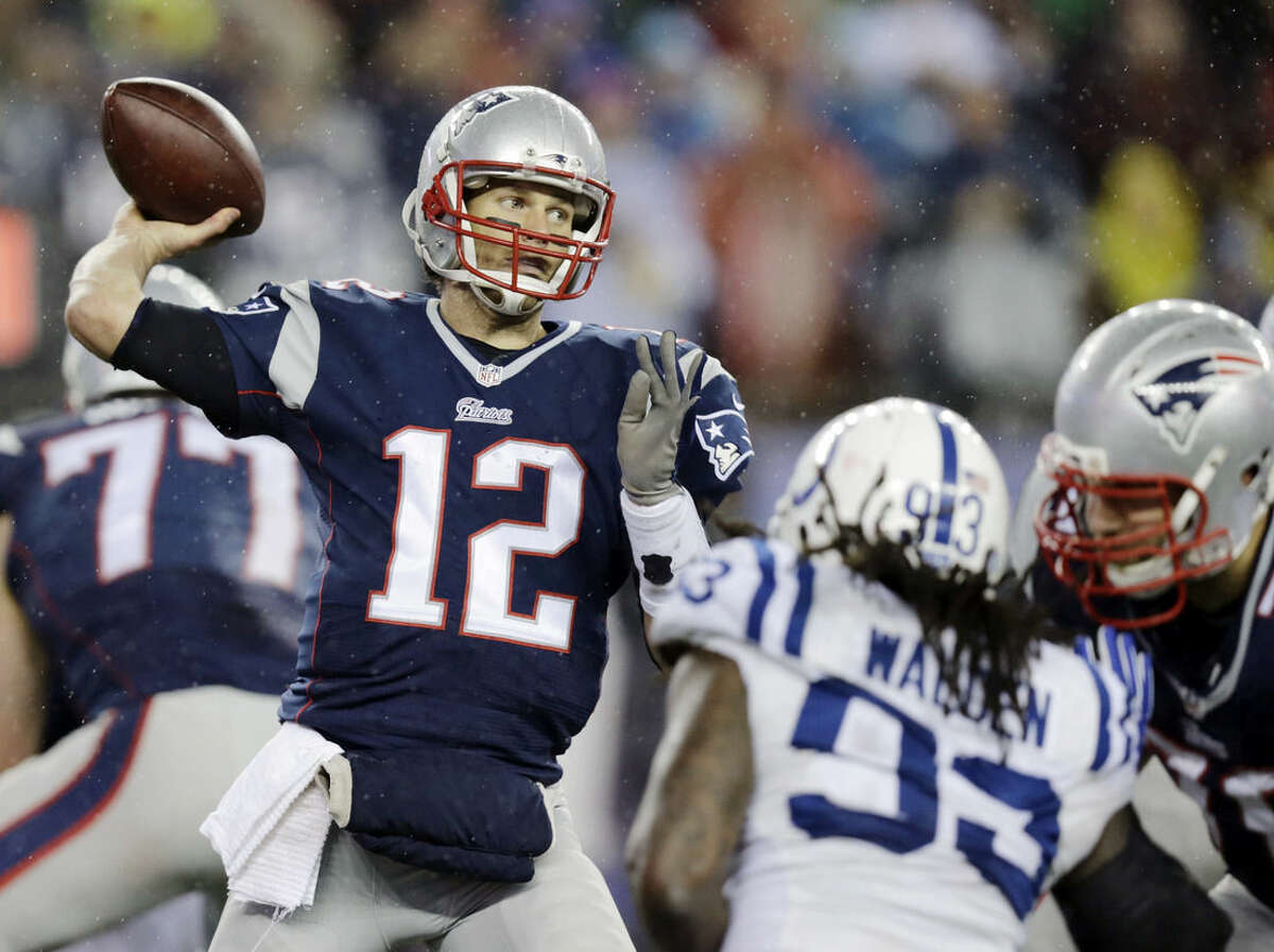 FILE - In this Jan. 18, 2015, file photo, New England Patriots quarterback Tom Brady (12) passes against the Indianapolis Colts during the second half of the NFL football AFC Championship game in Foxborough, Mass. An NFL investigation has found that New England Patriots employees likely deflated footballs and that quarterback Tom Brady was "at least generally aware" of the rules violations. The 243-page report released Wednesday, May 6, 2015, said league investigators found no evidence that coach Bill Belichick and team management knew of the practice. (AP Photo/Charles Krupa, File)