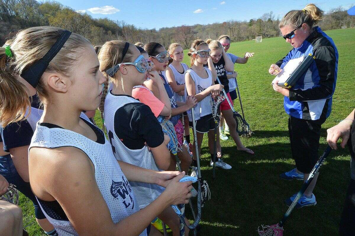 Coach Joanne Lussier works with the 7A travel girls lacrosse team in Wilton, all are wearing the Triax Sensor.