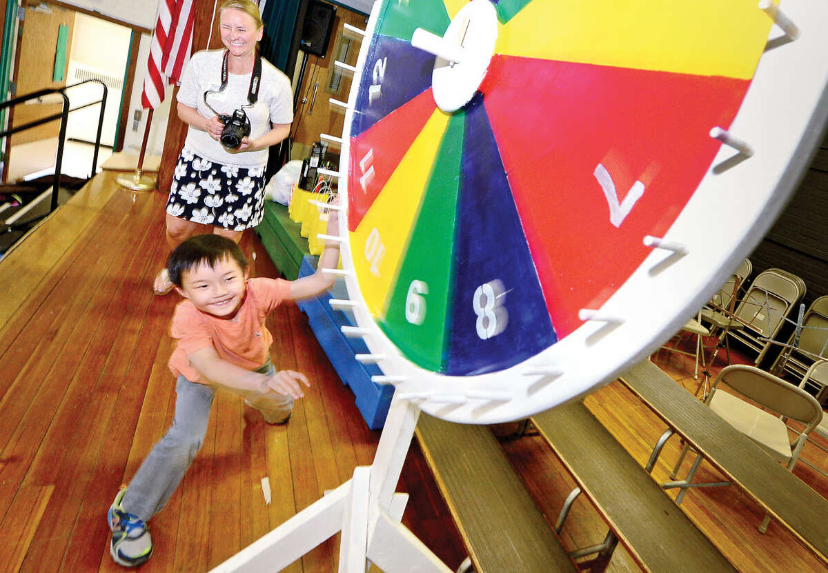 Hour photo / Erik Trautmann Rowayton Elementary School first grader Brian Fogerty spins the wheel for a prize as part of Hype Week in advance of the school's acrnival this weekend.
