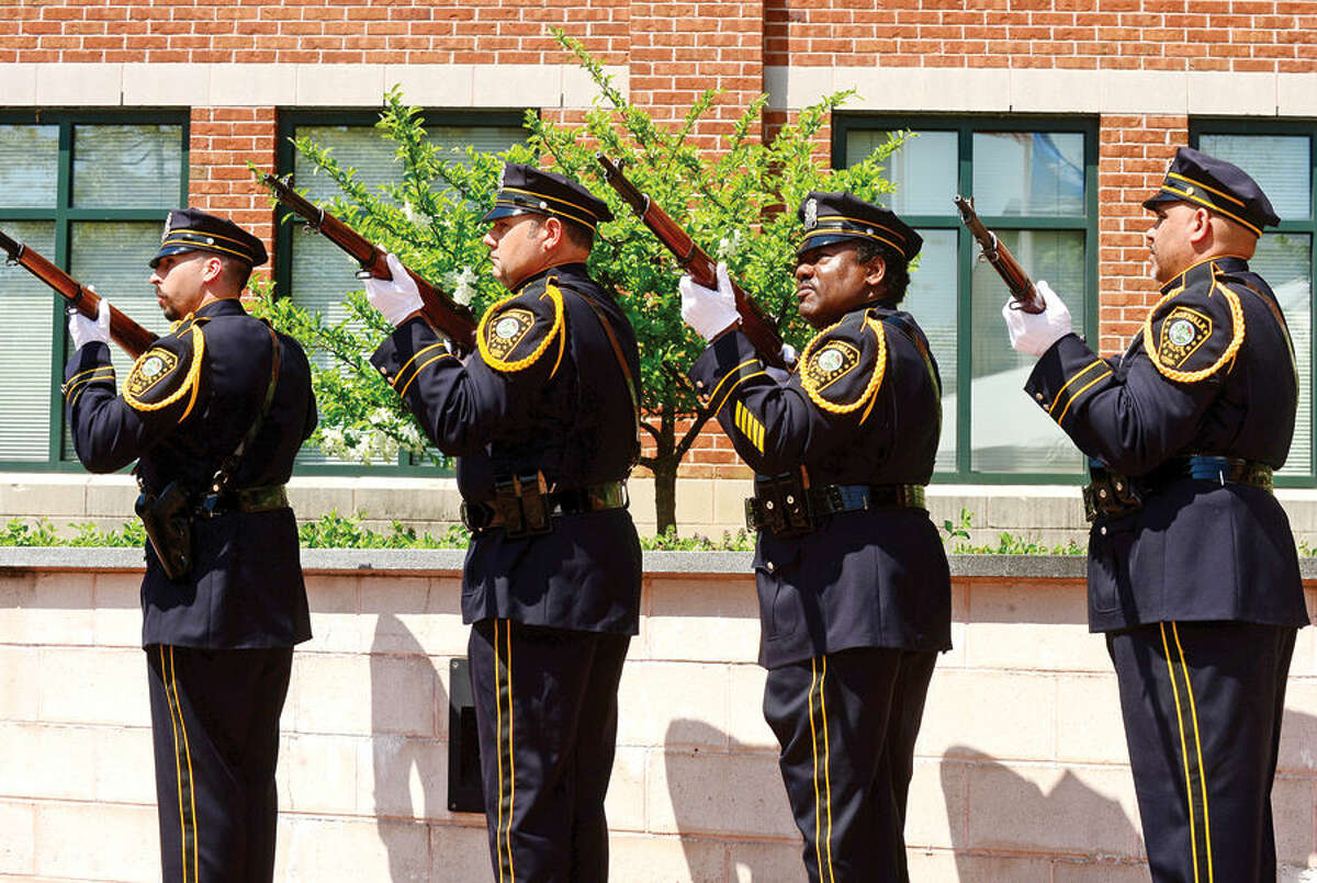 Hour photo / Erik Trautmann The Norwalk Police DEaprtment Honor Guard fire a volley salute during the annual Norwalk Police Department Police Memorial Service Friday at police headquarters.