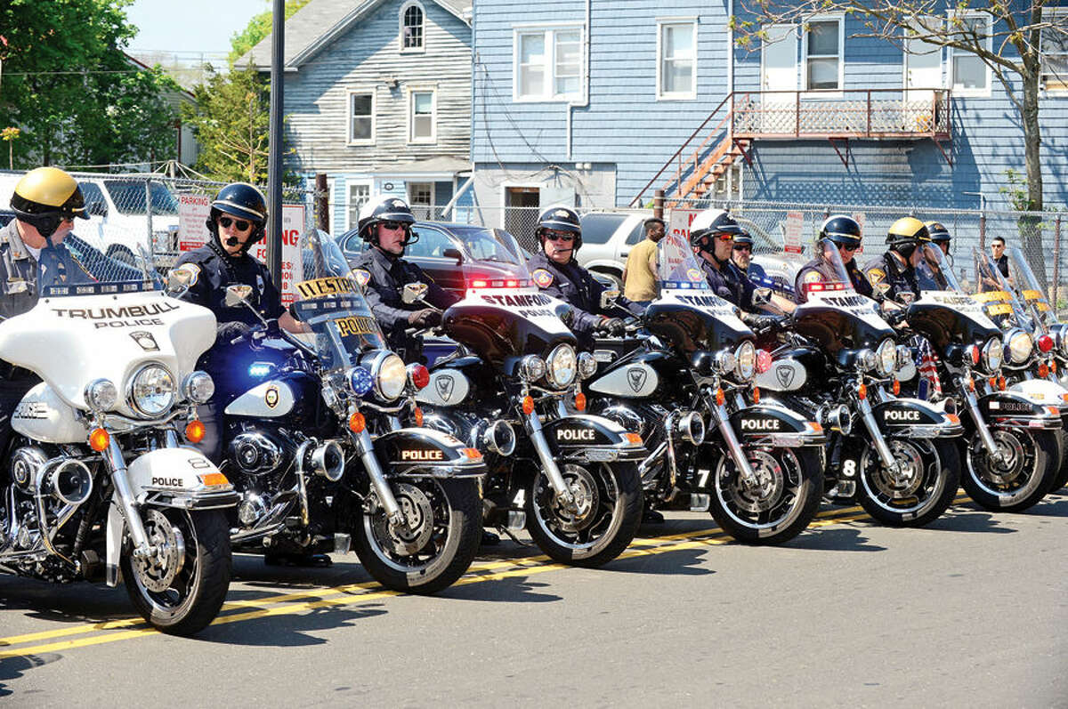 Hour photo / Erik Trautmann Motorcycle police from Fairfield County arrive at the annual Norwalk Police Department Police Memorial Service Friday at police headquarters.