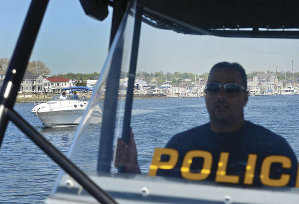 Hour photo / Erik Trautmann Norwalk marine police officers Rich Dellalo and Mike Silva promote water sfaety as they patrol Norwalk Harbor and surrounding waters.
