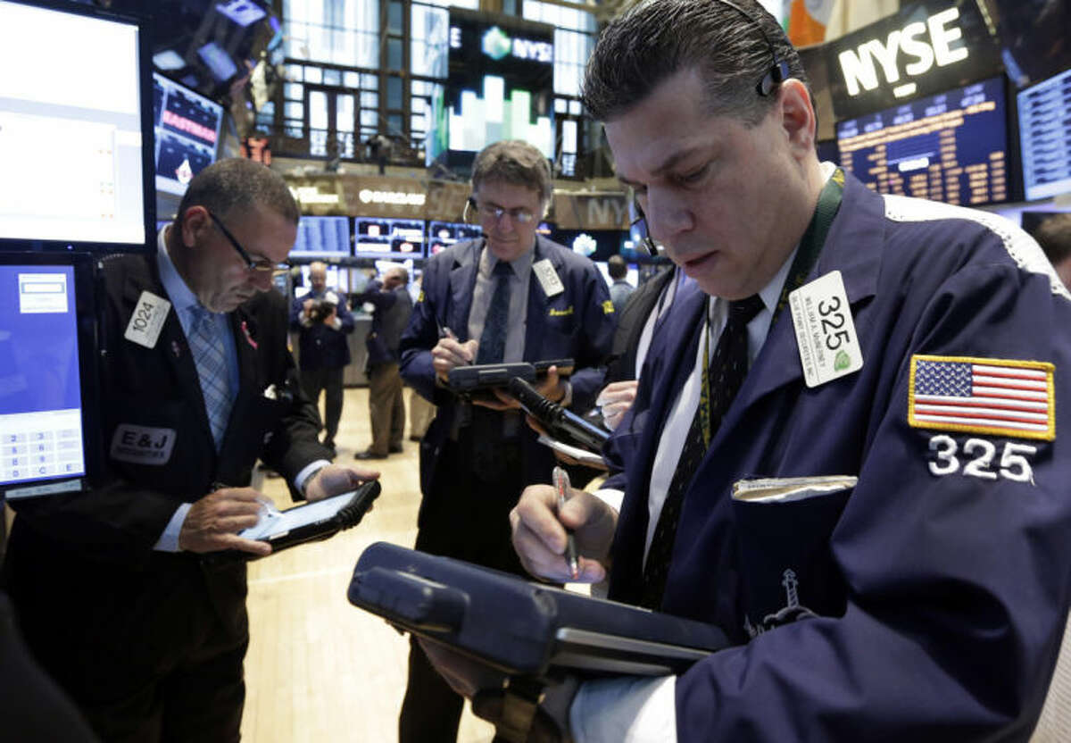 Trader William McInerney works on the floor of the New York Stock Exchange Wednesday, April 23, 2014. A six-day rally on the stock market is petering out as some U.S. companies report earnings that disappoint investors. (AP Photo/Richard Drew)