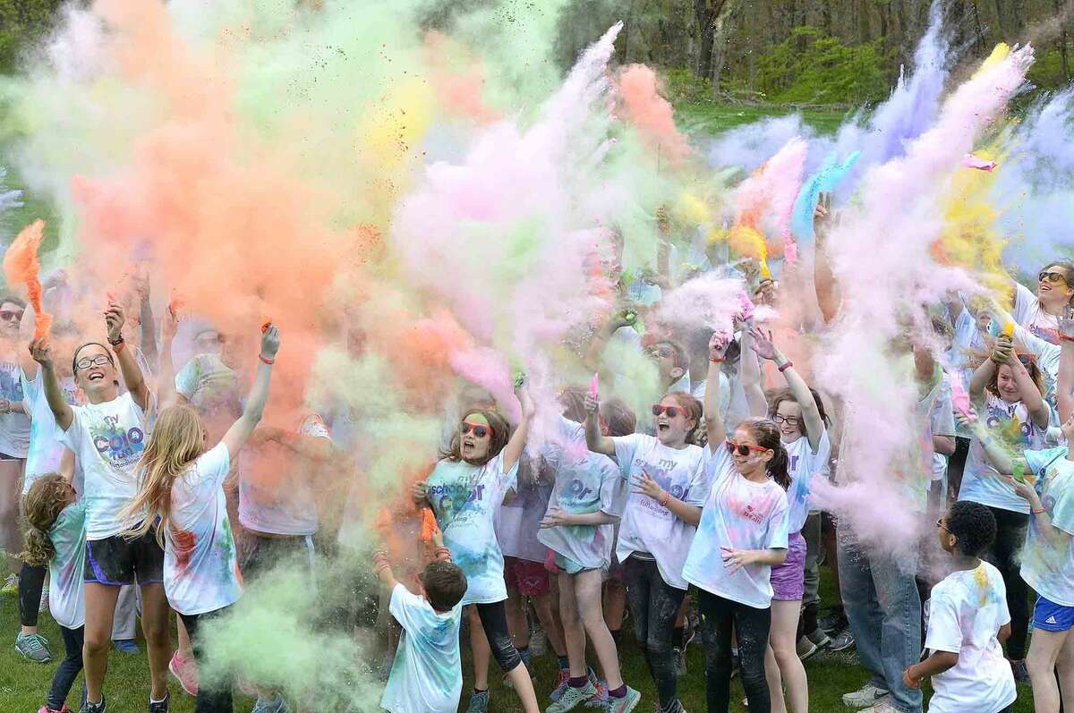 Wilton Youth Council's Youth to Youth club's new fundraising event called "My School Color Run," at Middlebrook School in Wilton, where participants walk/run a set course and get doused with spray color from Middlebrook staff during their run on Thursday May 5 2016 in Wilton Conn.