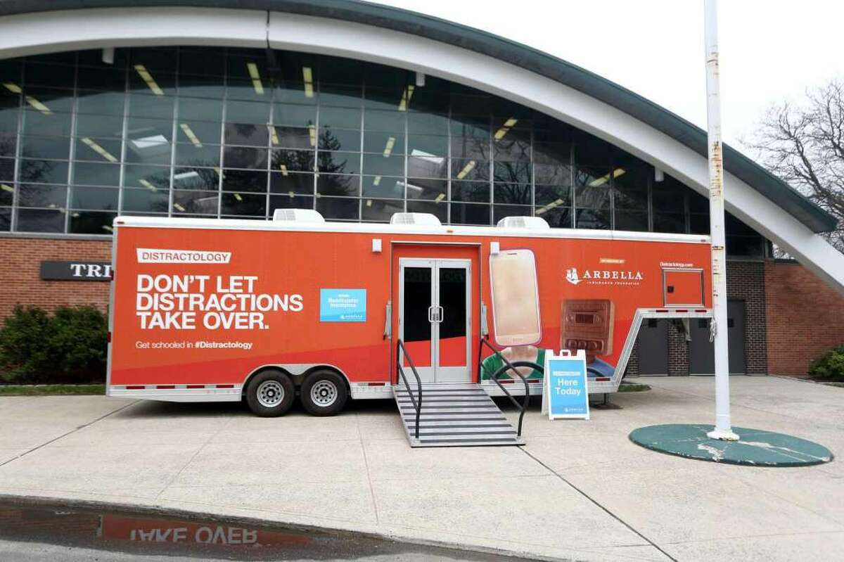 Bearingstar Insurance's distracted driving training mobile made a stop at Trinity Catholic High School, letting students use the distracted driving simulator to help them understand the dangers of the road, on Thursday, May 5, 2016. (Photo: Michael Cummo / Hearst Connecticut Media)