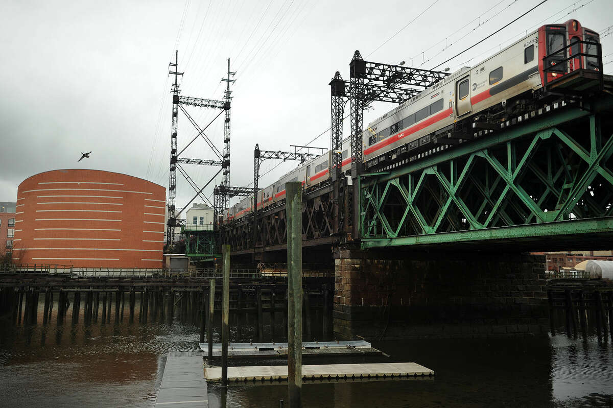 A Metro-North train heads east across the Walk Bridge over the Norwalk River in Norwalk last month.