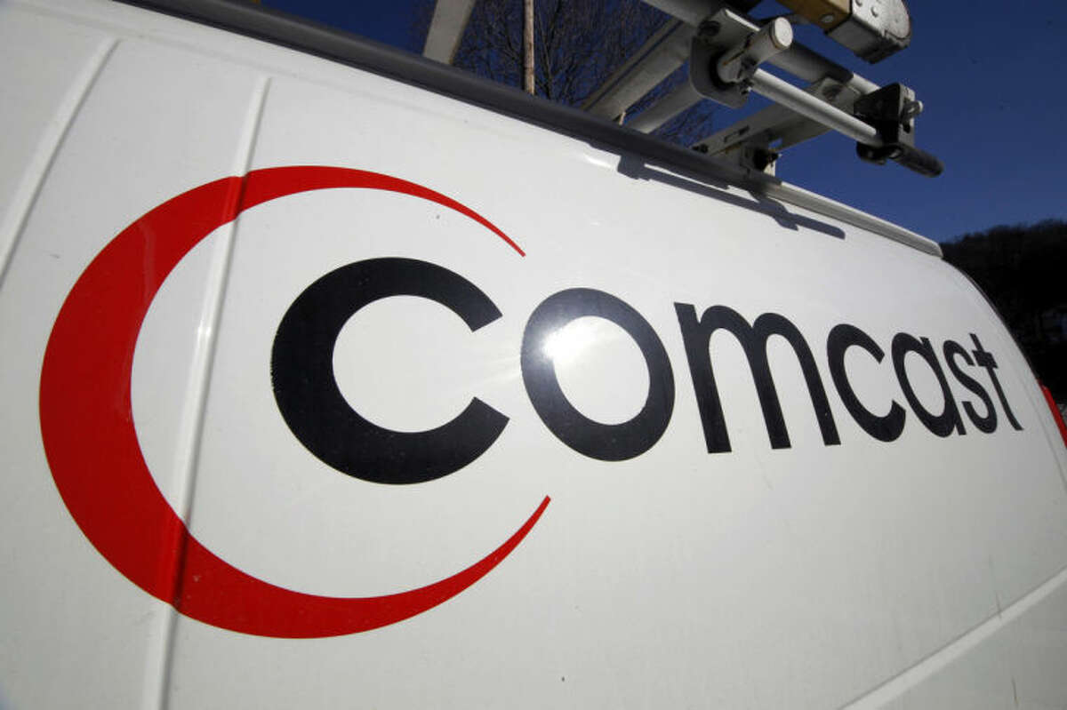 FILE - This Feb. 11, 2011, file photo, shows the Comcast logo on one of the company's vehicles, in Pittsburgh. Comcast plans to sell some cable systems to competitor Charter Communications Inc., to help Comcast?’s acquisition of Time Warner Cable clear regulatory hurdles, the company announced Monday, April 28, 2014. (AP Photo/Gene J. Puskar, File)