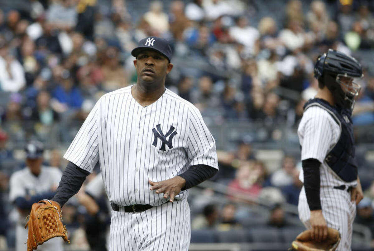 New York Yankees starting pitcher CC Sabathia flexes his pitching hand while leaving a baseball game after giving up a fourth-inning double to Tampa Bay Rays' Wil Myers at Yankee Stadium in New York, Sunday, May 4, 2014. (AP Photo/Kathy Willens)