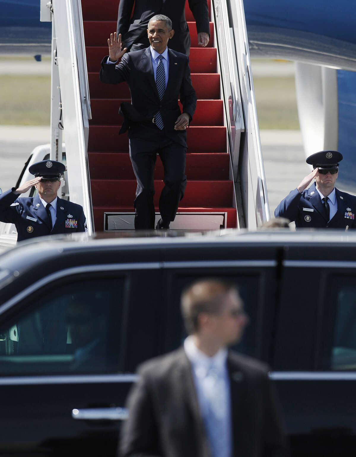 President Barack Obama waves as he arrives on Air Force One at Groton-New London Airport, Wednesday, May 20, 2015, in Groton, Conn. before giving the commencement address at the Coast Guard Academy. (AP Photo/Jessica Hill)