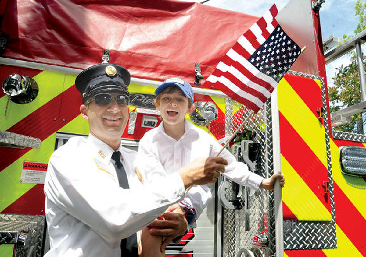 Mark Pinzon with the Rowayton Fire department and his son Jackson 7, at the annual Memorial Day Parade on Sunday. Hour photo/Matthew Vinci