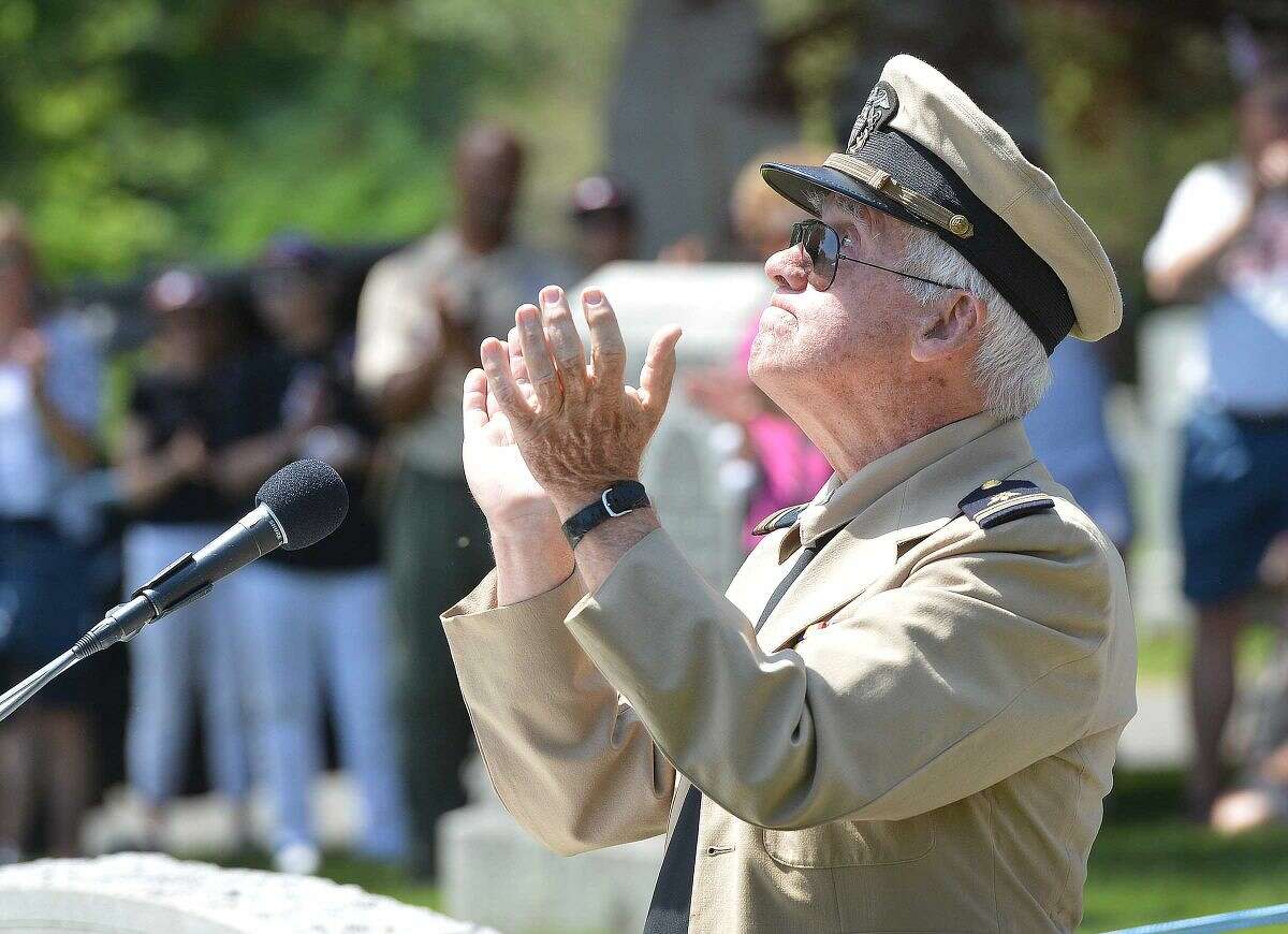 Hour Photo/Alex von Kleydorff Keynote speaker Navy Lt. Jr. Grade (Ret) Jack Majesky looks to the sky as he encorages everyone to applaude those who gave their lives in the service of their country, during a service at Hillside Cemetery in Wilton on Memorial Day