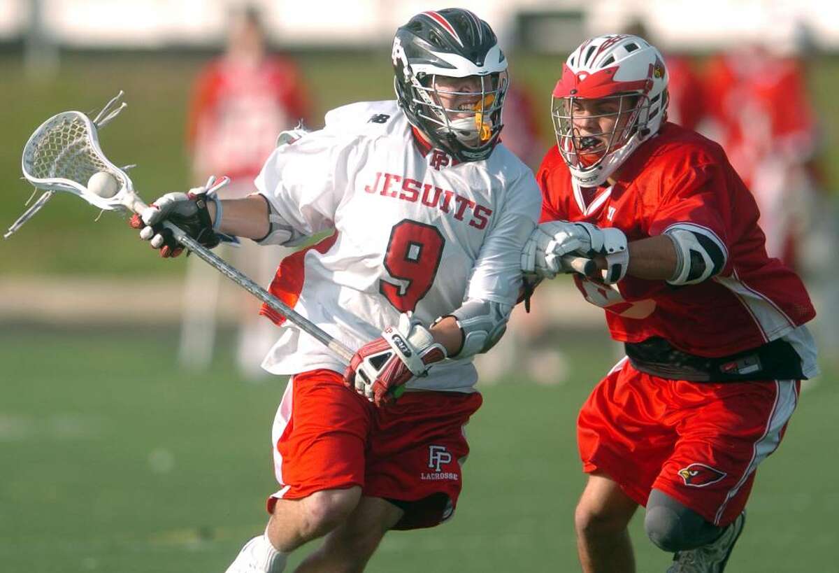 Fairfield Prep's Michael Carey controls the ball as Greenwich's Chris Wolfe defends Thursday Apr. 22, 2010 during their match at Fairfield University's Alumni Field.