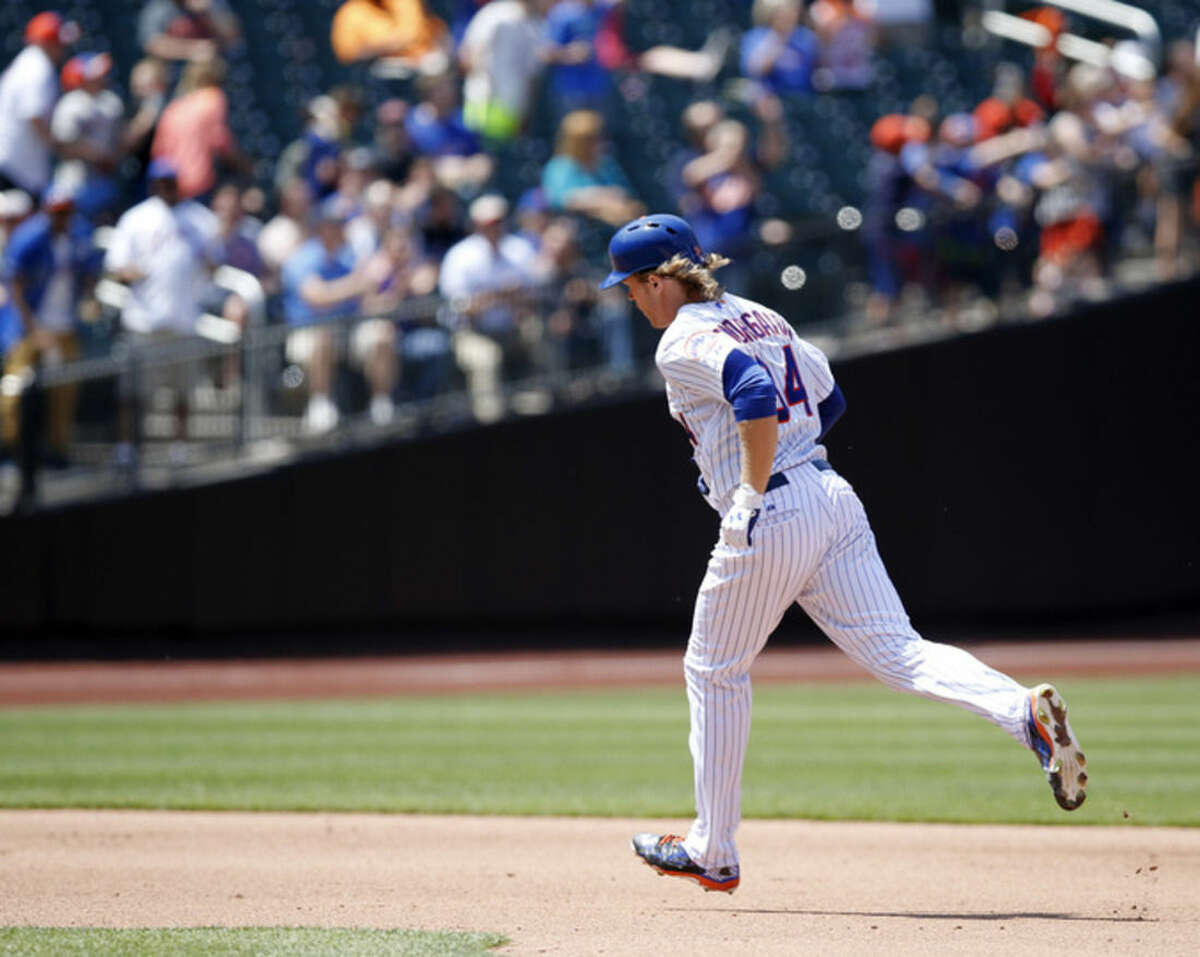 New York Mets Noah Syndergaard trots the bases after hitting a fourth-inning, solo home run off Philadelphia Phillies starting pitcher Sean O'Sullivan in a baseball game in New York, Wednesday, May 27, 2015. (AP Photo/Kathy Willens)
