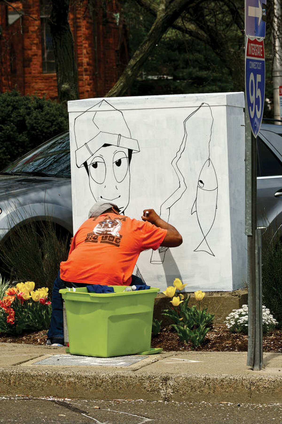 Hour photo / Erik Trautmann Norwalk artist Dooly-O paints a elctrical box along Martin Luther King BLVD as part of the Urban Art program which transforms traffic boxes along city streets in South Norwalk.