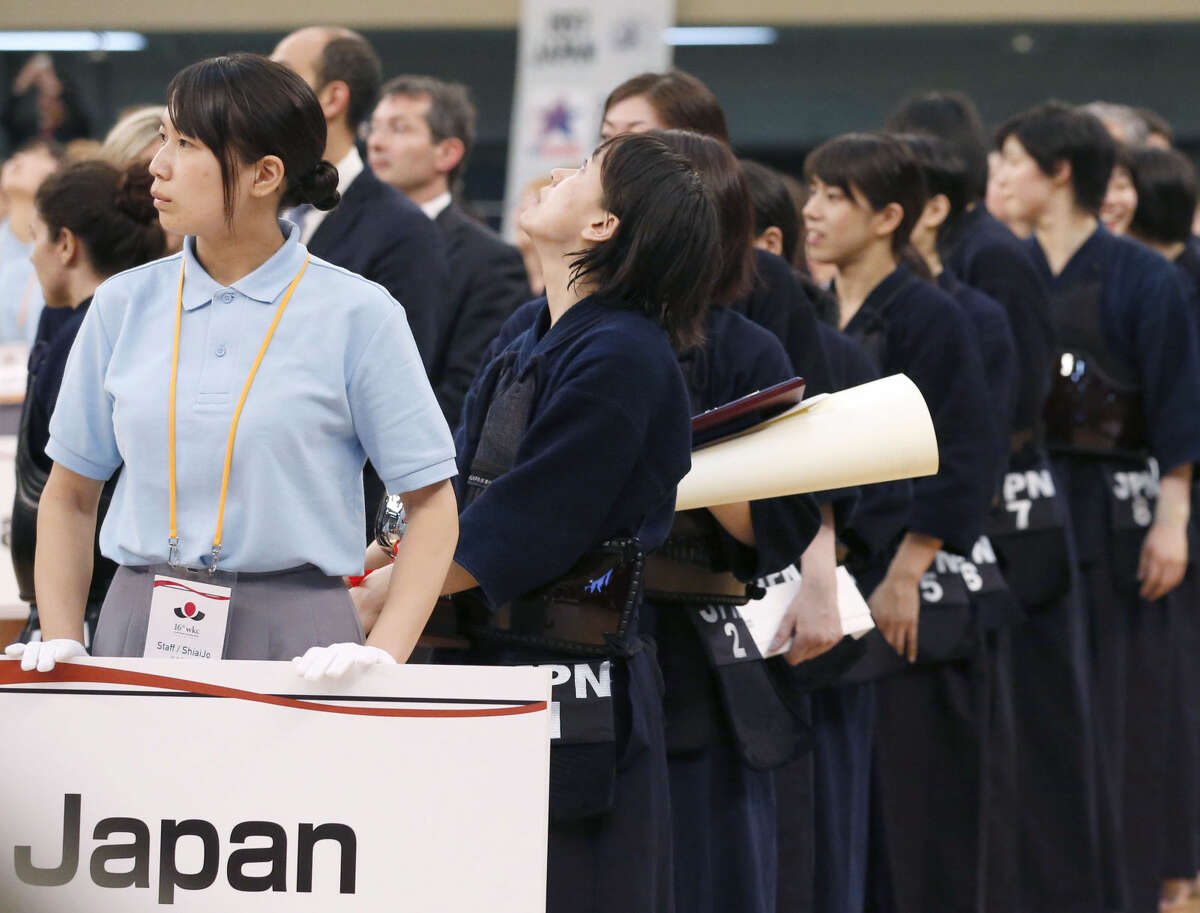 A Japanese kendo player looks up the ceiling as a strong earthquake jolts Nippon Budokan martial arts hall during an awarding ceremony for the World Kendo Championships in Tokyo Saturday, May 30, 2015. A powerful and extremely deep earthquake struck a group of remote Japanese islands and shook Tokyo on Saturday, but officials said there was no danger of a tsunami, and no injuries or damage were immediately reported. (Meika Fujio/Kyodo News via AP)