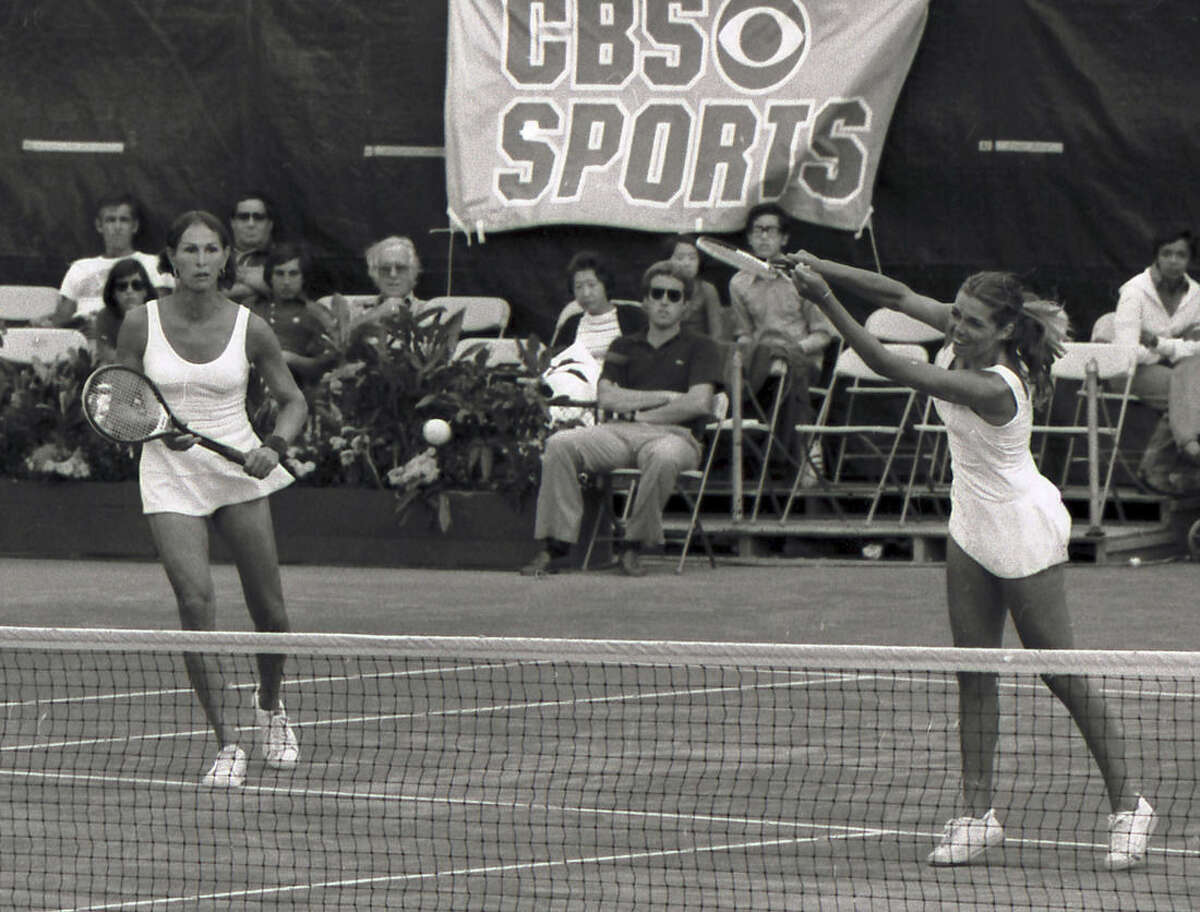 FILE - In this September, 1977 file photo, Renee Richards, left, watches as Betty Ann Stuart hits during the U.S. Open women's doubles championship tennis match against Betty Stove and Martina Navratilova at Forest Hills, N.Y. Richards, who was denied the opportunity to play as a woman in the 1976 U.S. Open, was born Richard Raskind, a former captain of the Yale tennis team who had sex reassignment surgery. (AP Photo, File)