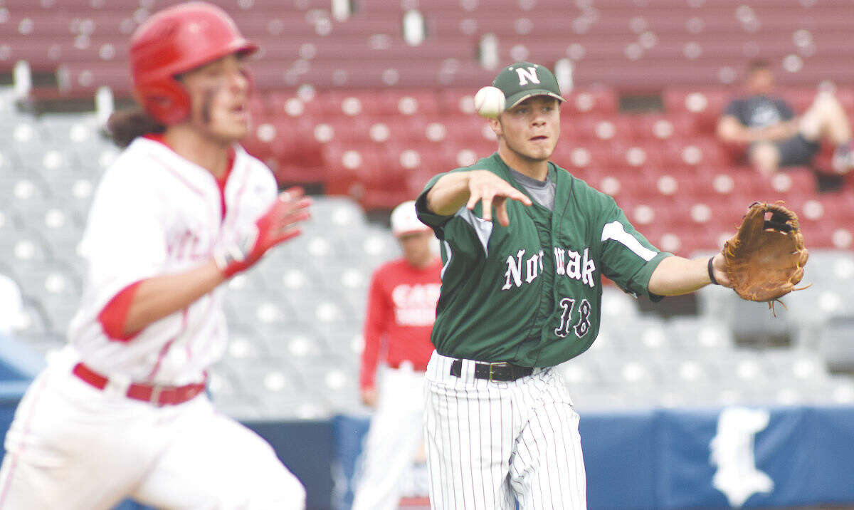 Hour photo/John Nash - Norwalk starting pitcher Dave Balunek, right, fires to first to beat NFA's Griffen Gooden on a comebacker to the mound.