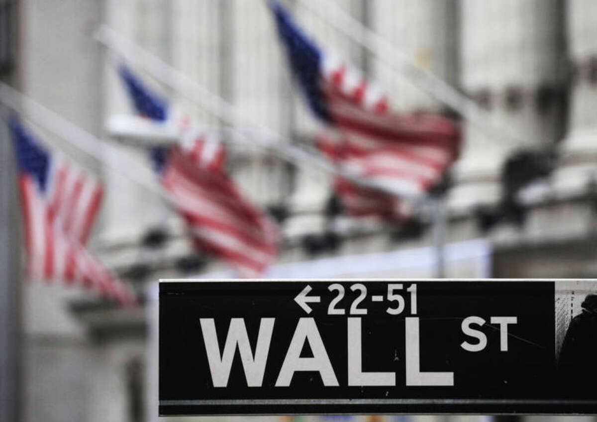 FILE - This April 22, 2010, file photo, shows a Wall Street sign in front of the New York Stock Exchange. U.S. stocks slumped Thursday, July 31, 2014, as investors reacted to disappointing corporate earnings reports and assessed the implications of the approaching end to economic stimulus from the Federal Reserve. (AP Photo/Mark Lennihan, File)