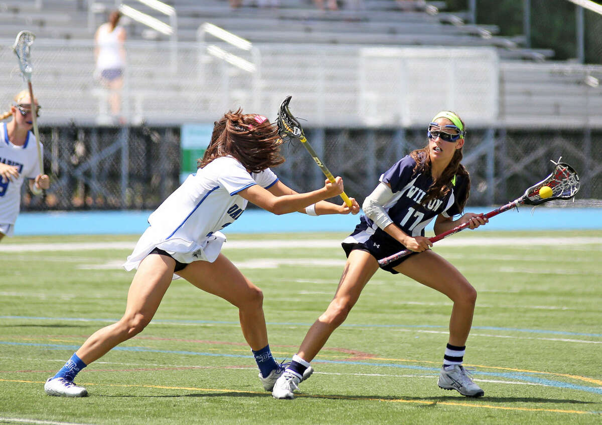 Wilton's #17, Laine Parsons, prepares to make a pass during the Girls Lacrosse State Final at Bunnell High School in Stratford Saturday morning. Hour Photo / Danielle Calloway