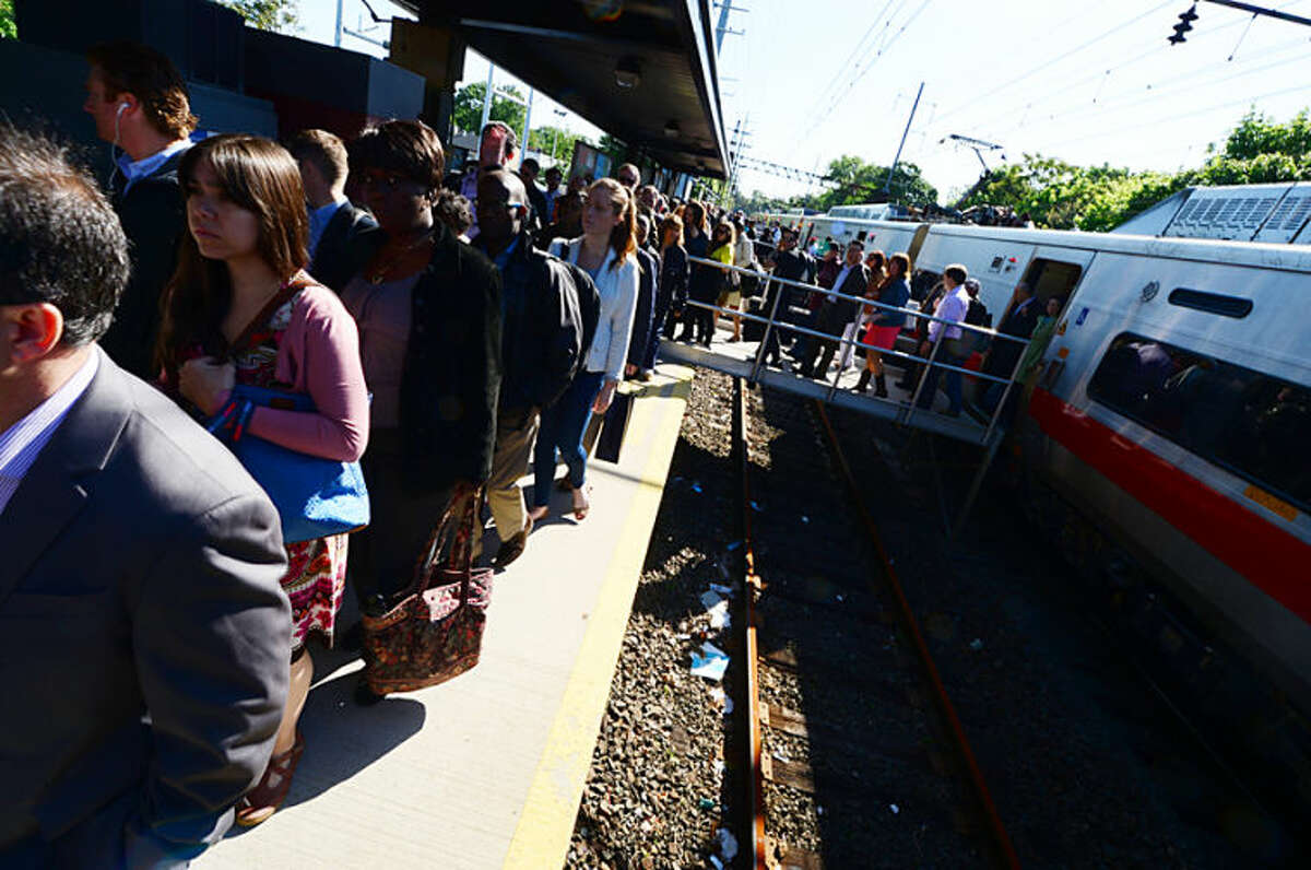 Hour photo / Erik Trautmann Passengers disembark a Eastbound Metro North train at East Norwalk after a 2 hour delay caused by a bridge failure at South Norwalk. Service was restored moments later.