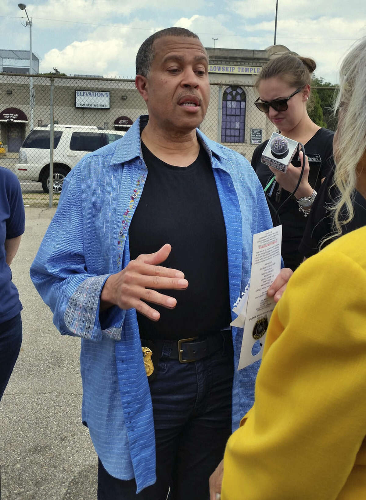Detroit Police Chief James Craig talks to reporters, Sunday, June 21, 2015, near the scene of a block party where three men exchanged gunfire on Saturday in Detroit. At least one person is dead and several wounded. (AP Photo/David N. Goodman)