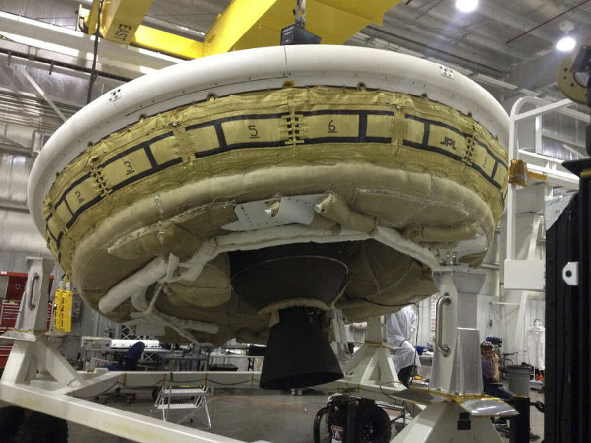 This undated image provided by NASA shows a saucer-shaped test vehicle holding equipment for landing large payloads on Mars in the Missile Assembly Building at the U.S Navy's Pacific Missile Range Facility at Kekaha on the island of Kaua?‘i in Hawaii. The vehicle, part of the Low Density Supersonic Decelerator project, will test an inflatable decelerator and a parachute at high altitudes and speeds over the Pacific Missile Range scheduled for June 1, 2014. (AP Photo/NASA)