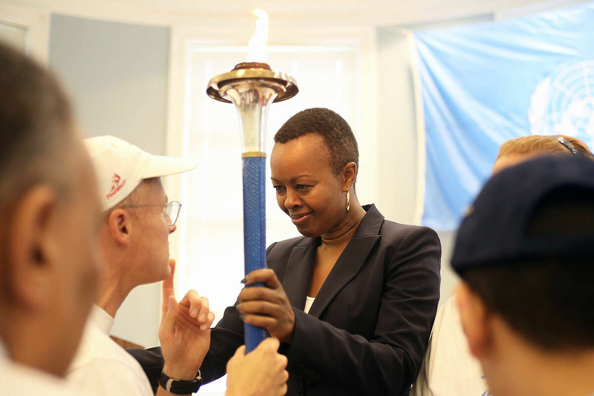 Guest of Honor, Ms. Carol Wainaina, holds the Torch of Peace on behalf of the United Nations during Westport's 50th jUNe Day Celebration Ceremony at Saugatuck Elementary School Saturday morning. Hour Photo / Danielle Calloway