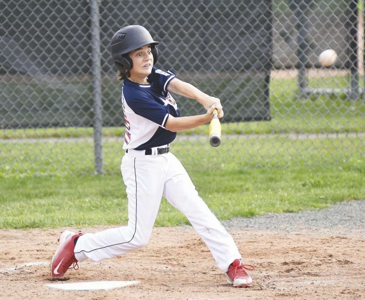 Hour photo/John Nash Westport Little League 12-year-old All-Star batter John DeDomenico's eyes light up as he rips into a pitch that turns into a two-run home run during Thursday's District 2 tournament game at Unity Park in Trumbull.