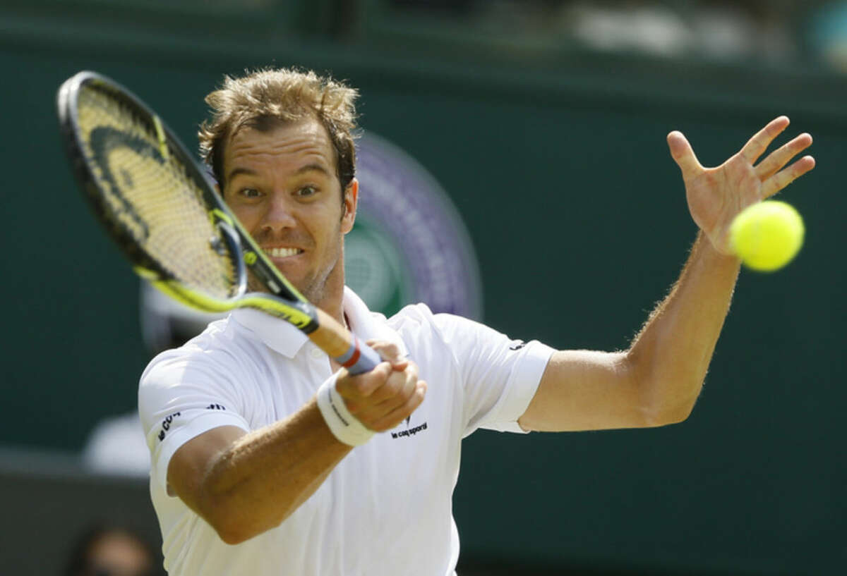 Richard Gasquet of France makes a return to Grigor Dimitrov of Bulgaria during their singles match at the All England Lawn Tennis Championships in Wimbledon, London, Friday July 3, 2015. (AP Photo/Kirsty Wigglesworth)