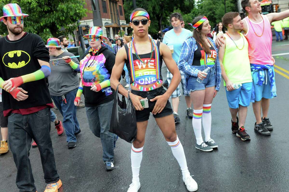 Jacob Tate, 18, of Latham, center, strikes a pose during the Capital PRIDE Parade on Saturday, June 11, 2016, in Albany, N.Y. The annual parade, festival and rally celebrates the Lesbian, Gay, Bisexual, Transgender and Queer community with entertainment and family-friendly activities. (Cindy Schultz / Times Union)