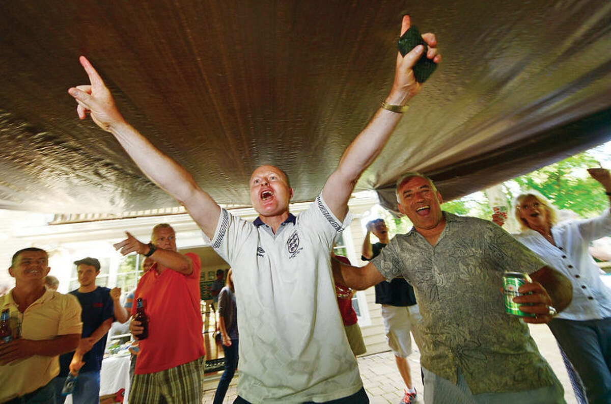 Wilton resident and World Cup fan Nick Slater hosts a World Cup viewing party with friends and neighbors. Here, Slater cheers on his favorite team England as they face off against Italy during an early round match.