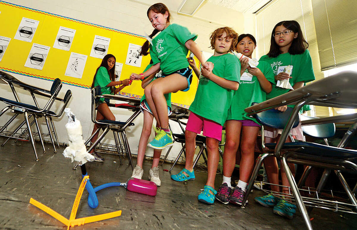 Hour photo / Erik Trautmann Miranda Silva-Meza launches a handmade rocket as Amazing Girls Science hosts a Camp Invention workshop for girls in grades 1 to 6 Thursday at Nathan Hale Middle School.
