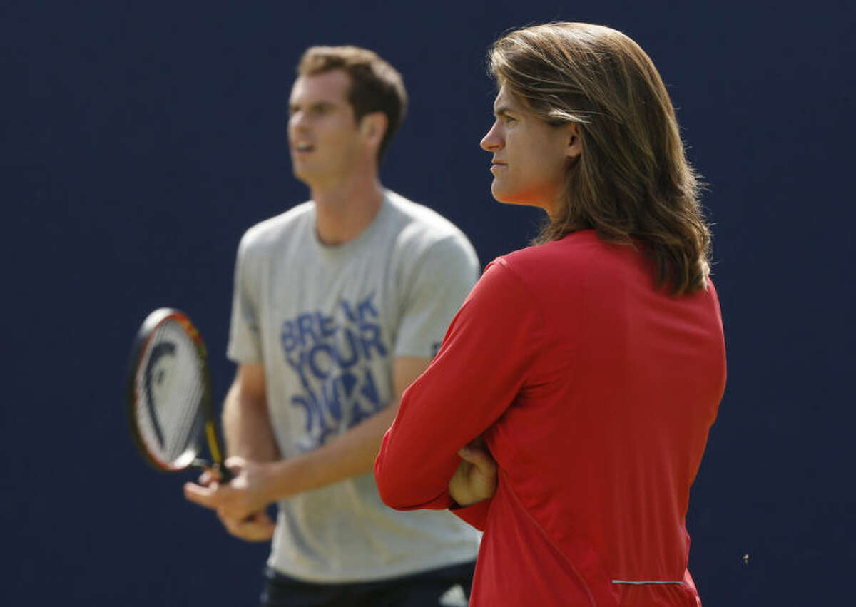 ADVANCE FOR WEEKEND EDITIONS, JUNE 21-22 - FILE - In this June 12, 2014, file photo, Andy Murray's new coach Amelie Mauresmo, right, watches him practice during a training session before his Queen's Club grass court championships tennis match in London. The pairing of defending champion Andy Murray and his new coach, Amelie Mauresmo, was quickly dubbed "Murresmo," and their partnership is sure to draw a lot of notice. (AP Photo/Sang Tan, File)