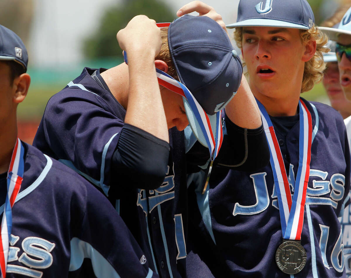San Antonio Johnson's Joseph Haight, left, adjusts his silver medal with Chris Bialick after their team fell to Dallas Jesuit 6-2 during the UIL State Baseball 6A championship in Round Rock Saturday, June 11, 2016.