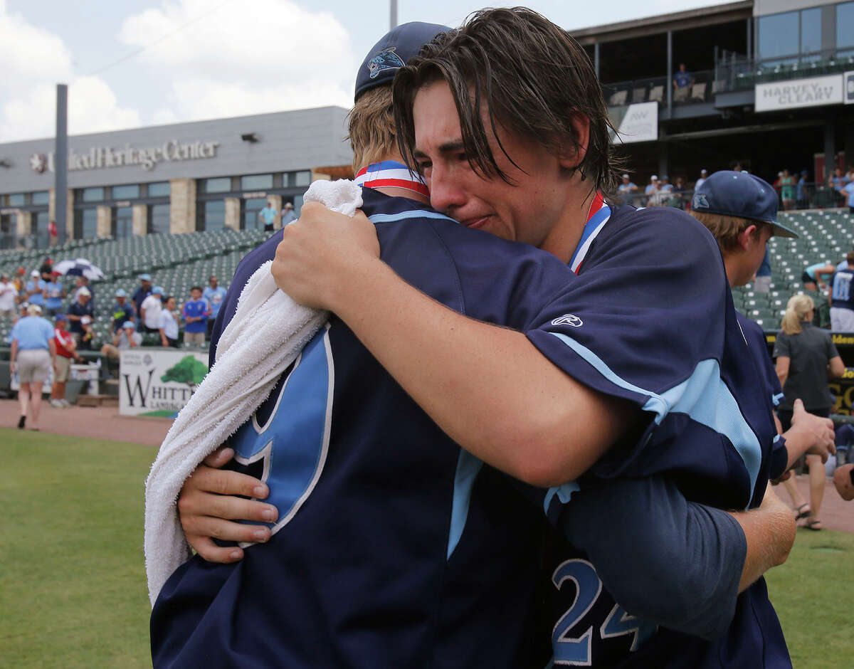 San Antonio Johnson's Bryce Faust (9) and Jaydan Martinez (24) hug after their team fell to Dallas Jesuit 6-2 during the UIL State Baseball 6A championship in Round Rock Saturday, June 11, 2016.