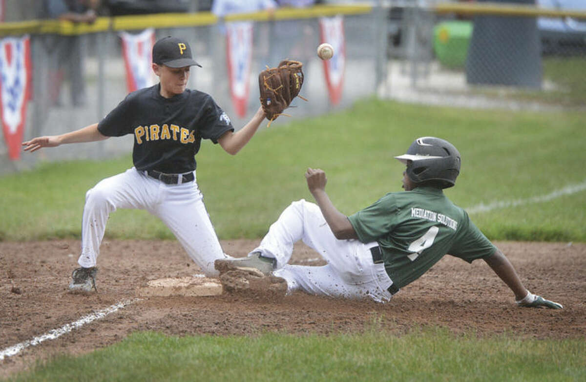 Photo by Alex von Kleydorff A's baserunner Zayvion Eusebe, right, slides safely into third base as Pirates player Spencer Reyes can't get the tag down in time during last week's Wilton Little League championship game.