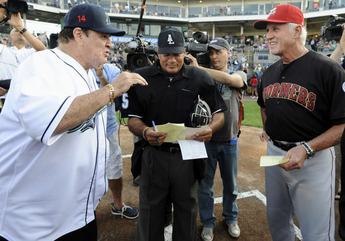 Pete Rose, left, and Lancaster Barnstormers manager Butch Hobson, right, talk at home plate before a game at The Ballpark at Harbor Yard, Monday, June 16, 2014, in Bridgeport, Conn. Rose, banned from Major League Baseball, returned to the dugout for one day to manage the independent minor-league Bridgeport Bluefish. (AP Photo/Jessica Hill)