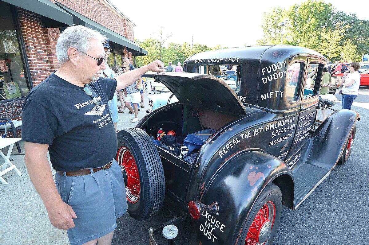 Hour Photo/Alex von Kleydorff Pete Everson opens the trunk of his original 1931 Ford Model A, complete with period phrases painted all over the body duringThe 15th annual Wilton Kiwanis, Geeb Fleming/Nick Allegretta Memorial Cruise Night