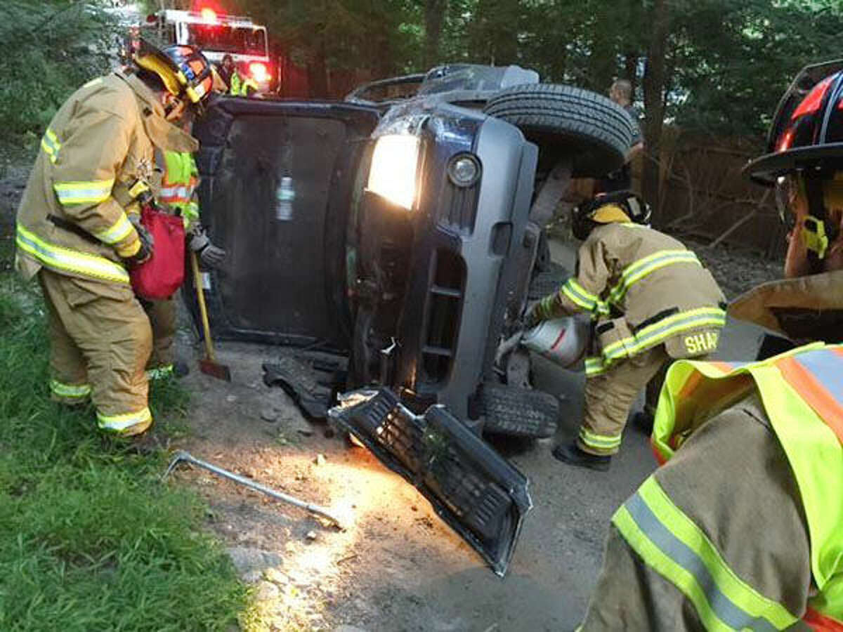 Photo courtesy Weston Fire Department Weston Fire and Police respond to a rollover accident on Newtown Turnpike early Friday morning. The lone driver was unharmed.