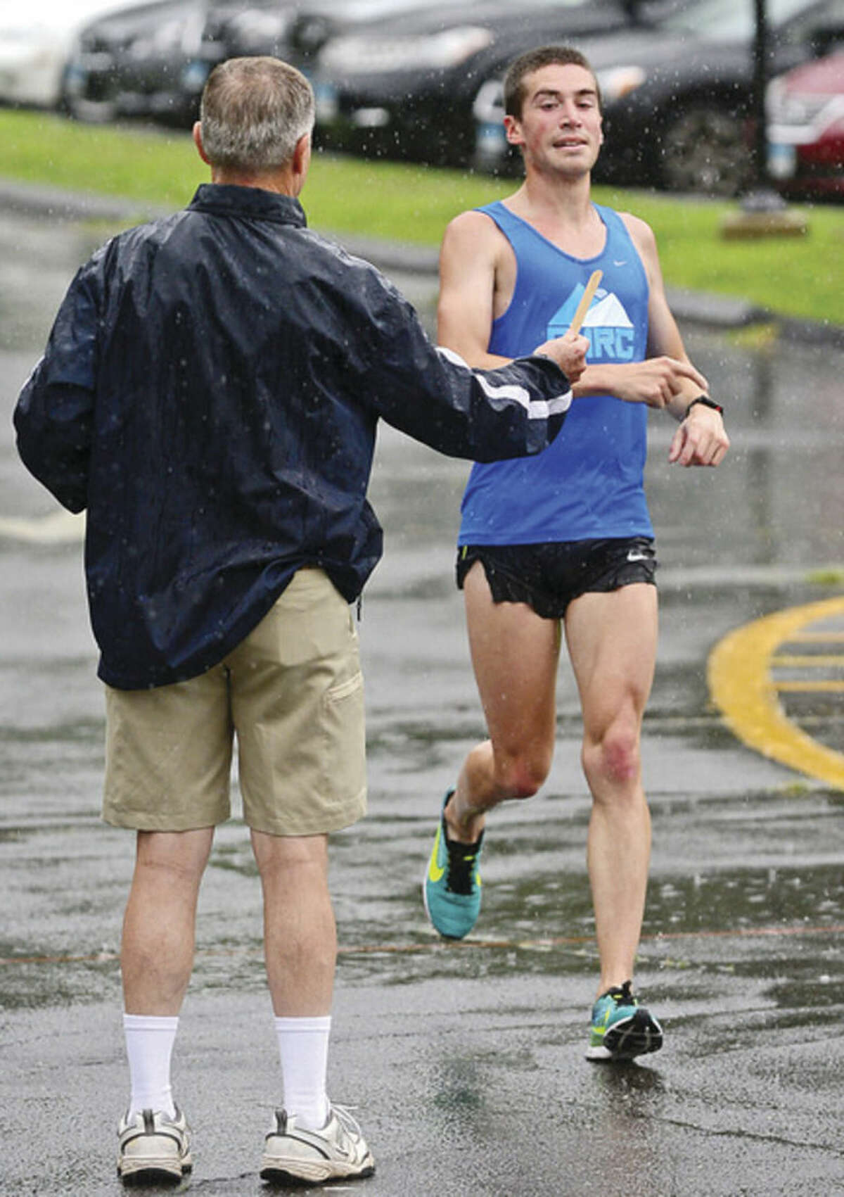 Hour photo / Erik Trautmann Kevin Hoyt finishes first as runners compete in the Westport Roadrunners Summer Series at Longshore Park in Westport Saturday.