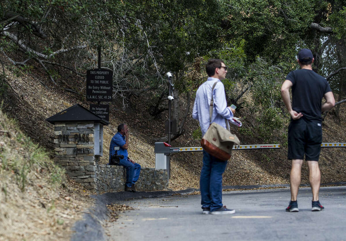 Members of the media wait outside of an entrance to to the home of actress Demi Moore, in Beverly Hills, Sunday, July 19, 2015. Coroner’s officials say a 21-year-old man accidentally drowned in the backyard pool of a Los Angeles home owned by actress Demi Moore. (AP Photo/Ringo H.W. Chiu)