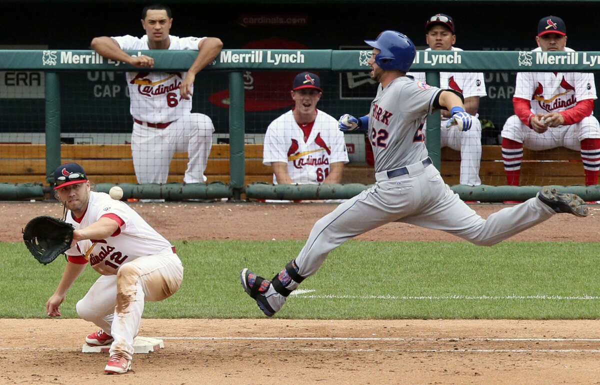 New York Mets' Kevin Plawecki (22) races the ball to first base as St. Louis Cardinals first baseman Mark Reynolds receives the throw during the 11th inning of a baseball game, Sunday, July 19, 2015 in St. Louis. (Chris Lee/St. Louis Post-Dispatch via AP) EDWARDSVILLE INTELLIGENCER OUT; THE ALTON TELEGRAPH OUT; MANDATORY CREDIT