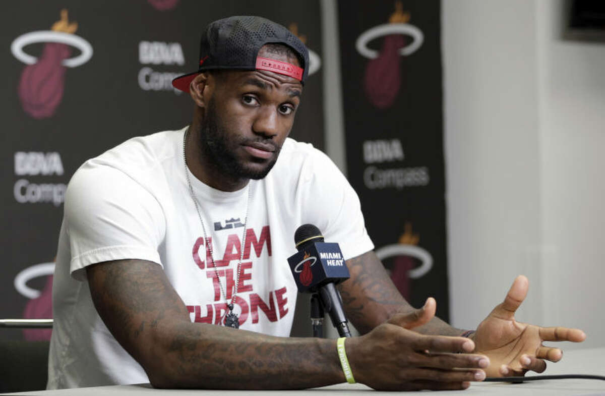FILE - In this June 17, 2014 file photo, Miami Heat's LeBron James gestures as he answers a question during a news conference in Miami. LeBron James held meetings for more than three hours in a Las Vegas hotel Tuesday, July 8, 2014 leaving without giving any indication of what team he?’ll play for next season. (AP Photo/Alan Diaz, File)