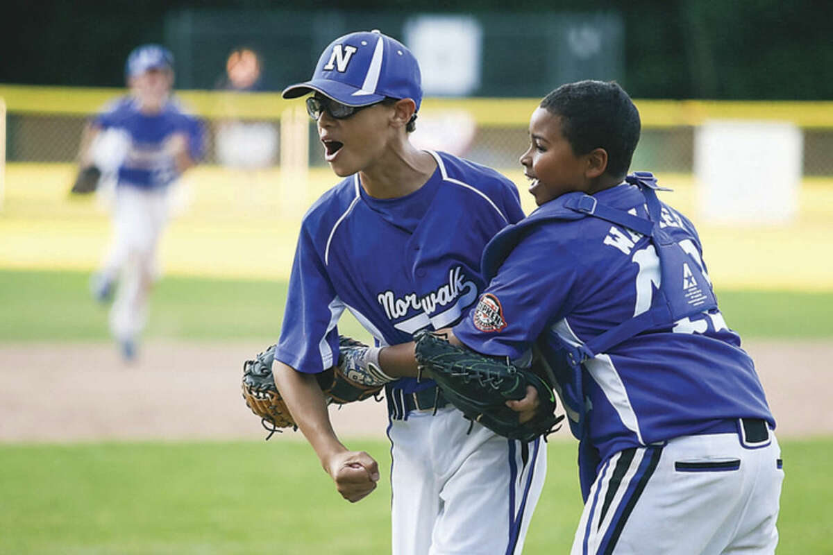 Hour photo/Chris Palermo Norwalk's Jeremy Cooke, left, and Kam Walker celebrate after their team's 9-8 win over Stratford in the Ripken 11-year-old state winner's bracket final on Thursday evening at Tim Devine Field.