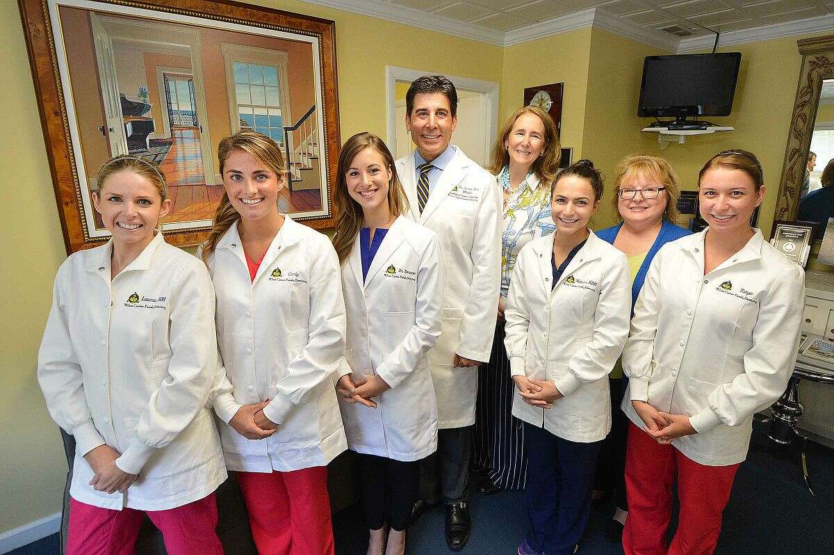 Dr. James Aris with his wife, Pamela, center, and staff. From left to right are: Laura Clements, Carly Herrera, Dr. Jaqueline Bonanno, Natalie Wall, Judy Klem and Tanya Ralph in their Wilton office.