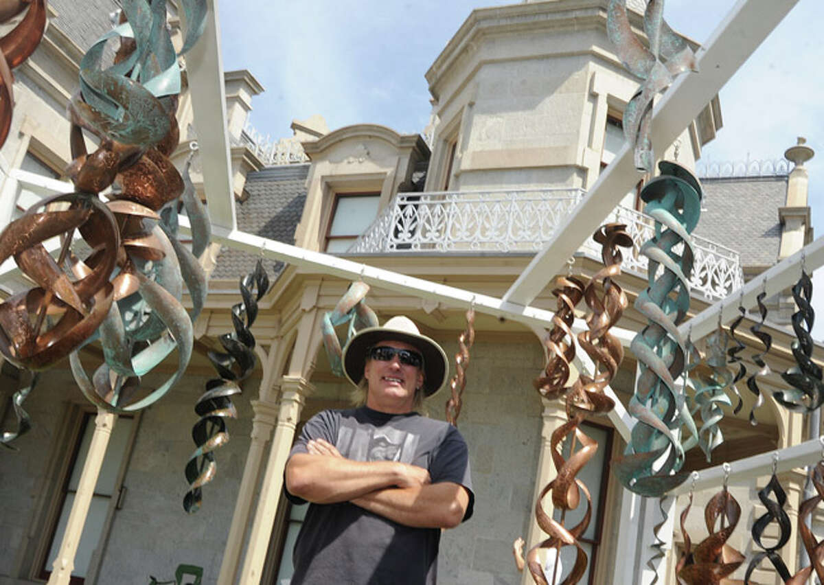Craig Riches with his hanging sculpture works Sunday at the Norwalk Art Festival held at Mathews Park. Hour photo/Matthew Vinci