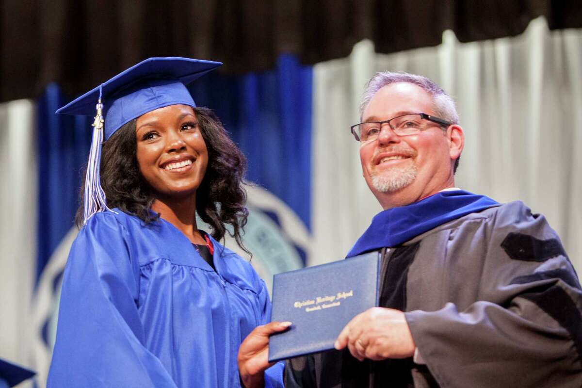 Lindsey Augustin smiles and accepts her diploma from Christian Heritage School's Head of School, Brian Modarelli at the Thirty-Third Commencement Exercises which took place in Trumbull, Conn. on Saturday, June 11, 2016.