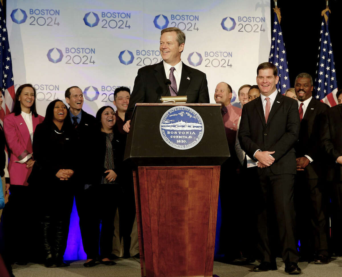 FILE - In this Jan. 9, 2015, file photo, Massachusetts Gov. Charlie Baker speaks during a news conference in Boston, as Boston Mayor Martin Walsh, second from right, and other looks on, after Boston was picked by the USOC as its bid city for the 2024 Olympic Summer Games. The leaders of the U.S. Olympic Committee are supposed to hear from the governor of Massachusetts on Monday, July 27, 2015. What he tells them could very well dictate the future of Boston's bid for the 2024 Olympics. (AP Photo/Winslow Townson, File)