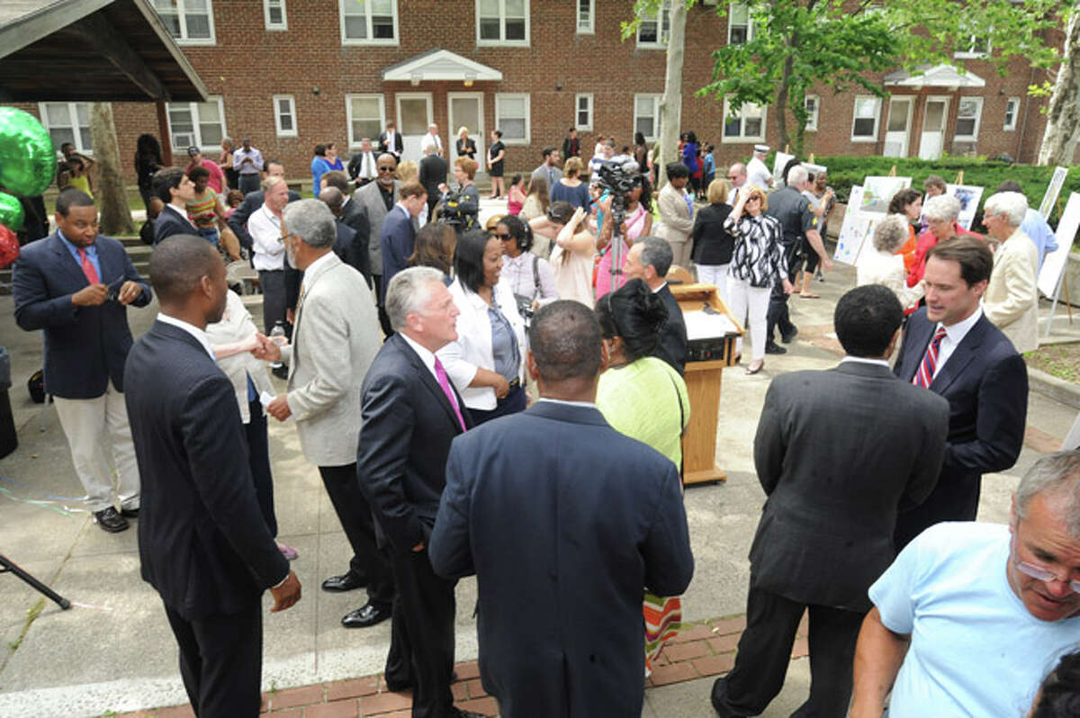 Residents and members of Congress, Councilman, police and clergy meet at Norwalk's Washington Village Monday as 30 million dollars was announced to rebuild the area. Hour photo/Matthew Vinci